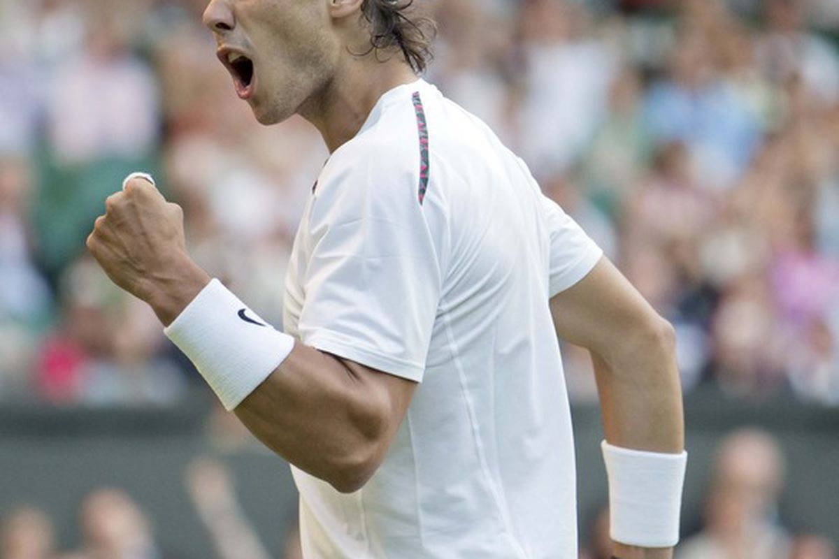 June 28, 2012; London, ENGLAND; Rafael Nadal (ESP) reacts during his match against Lukas Rosol (CZE) on day four of the 2012 Wimbledon Championships at the All England Lawn Tennis Club.  Mandatory Credit: Susan Mullane-US PRESSWIRE