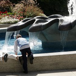 Boys play in the water on Temple Square during LDS Church Conference in Salt Lake City  Saturday, Oct. 1, 2011. 