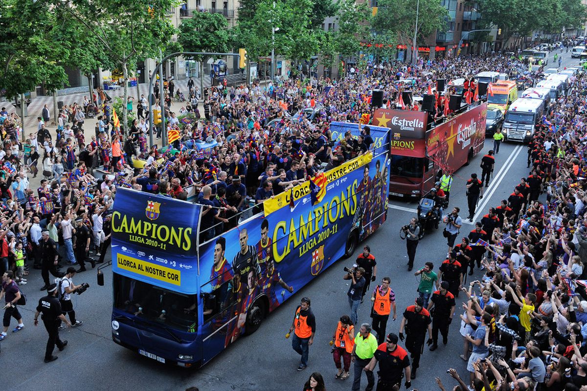 BARCELONA, SPAIN - MAY 13:  FC Barcelona players celebrate on the open top bus during the celebrations for winning the Spanish Liga on May 13, 2011 in Barcelona, Spain.  (Photo by David Ramos/Getty Images)