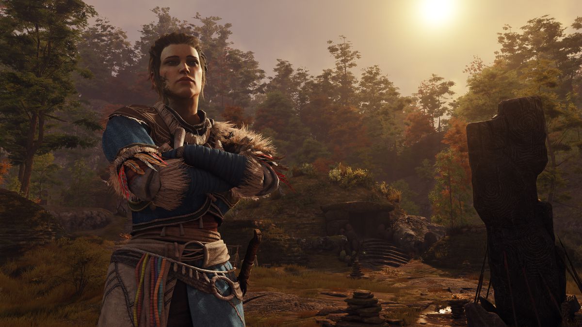 a white woman, De Sardet, stands with her arms crossed wearing a Native American outfit, with the sun hanging low above the trees behind her in GreedFall