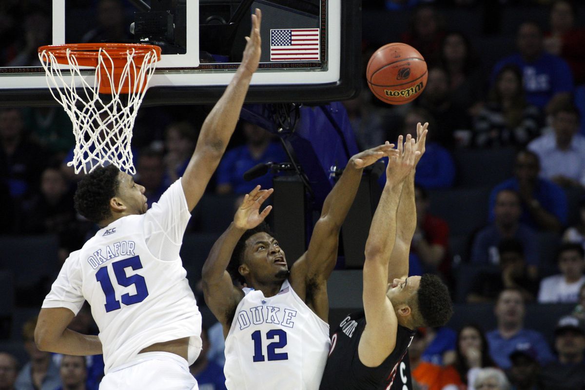 Mar 22, 2015; Charlotte, NC, USA; Duke Blue Devils forward Justise Winslow (12) blocks the shot of San Diego State Aztecs forward J.J. O'Brien (20) during the second half in the third round of the 2015 NCAA Tournament at Time Warner Cable Arena.