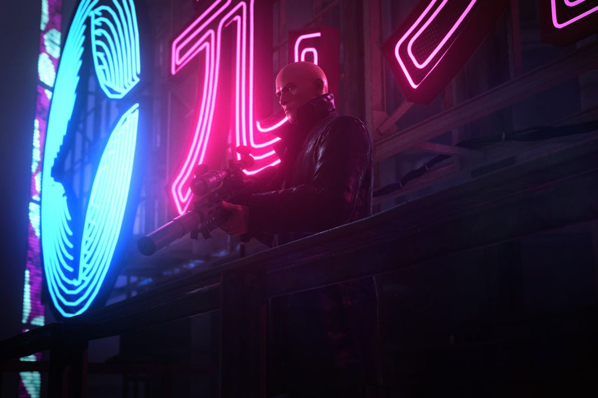 Agent 47 holds a sniper rifle in front of a neon sign in a screenshot from Hitman 3