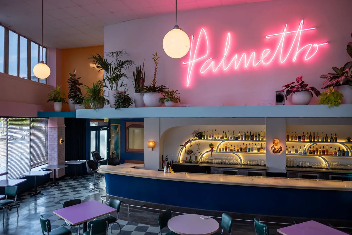 A neon sign reads, “Palmetto” and hangs above the bar area of this Oakland restaurant.