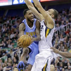 Denver Nuggets guard Will Barton (5) lays the ball up as Utah Jazz center Rudy Gobert, right, defends during the first half of an NBA basketball game Saturday, Dec. 3, 2016, in Salt Lake City. (AP Photo/Rick Bowmer)