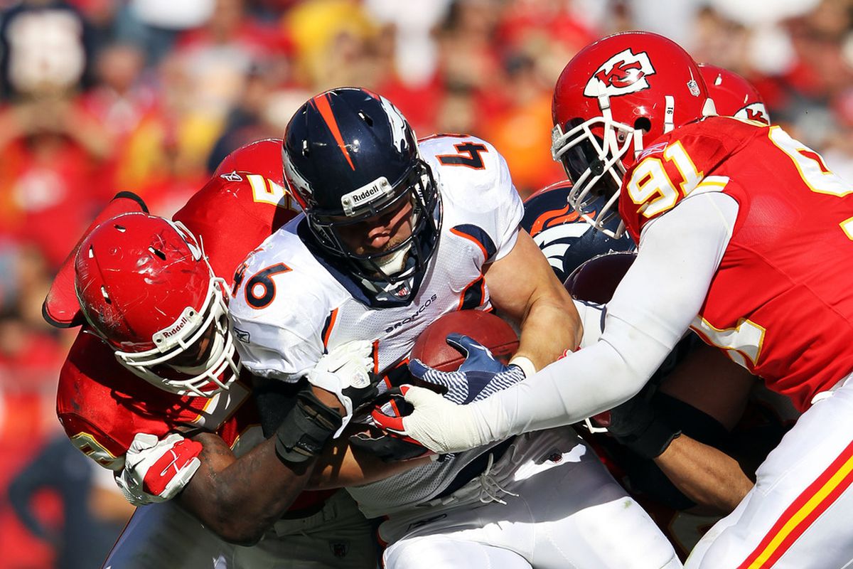 Spencer Larson of the Denver Broncos carries the ball as Tamba Hali of the Kansas City Chiefs defends during the game on November 13, 2011 at Arrowhead Stadium in Kansas City.  (Photo by Jamie Squire/Getty Images)