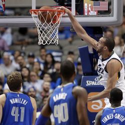 Utah Jazz center Rudy Gobert (27) dunks as Dallas Mavericks' Dirk Nowitzki (41), of Germany; Harrison Barnes (40); and Dorian Finney-Smith, right, watch during the first half of an NBA basketball game Thursday, March 22, 2018, in Dallas. (AP Photo/Tony Gutierrez)
