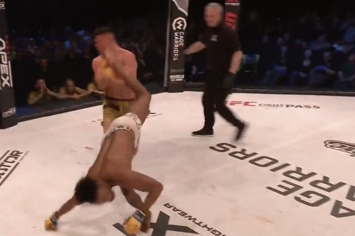 Manny Akpan [front] lands a capoeira-styled kick on Connor Hitchens to end their fight at CWFC 136.