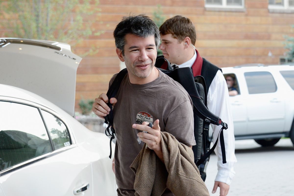 Former Uber CEO Travis Kalanick gets in his car while a bellboy puts luggage in the trunk