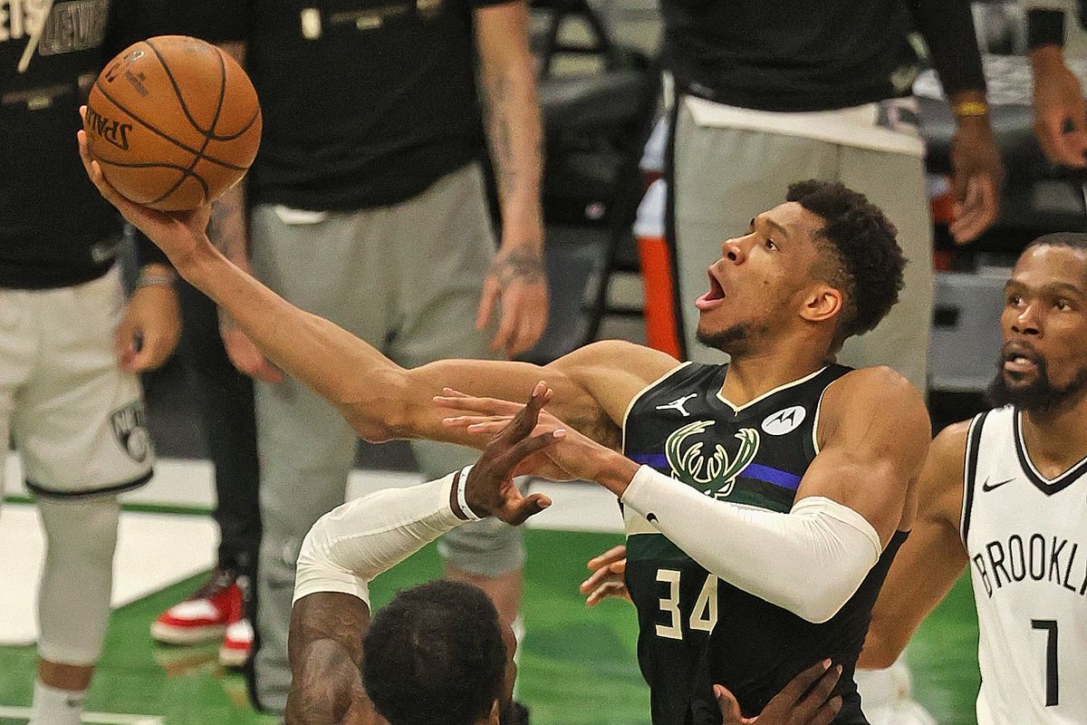 Giannis Antetokounmpo #34 of the Milwaukee Bucks shoots over Jeff Green #8 of the Brooklyn Nets at Fiserv Forum on June 17, 2021 in Milwaukee, Wisconsin. The Bucks defeated the Nets 104-89.