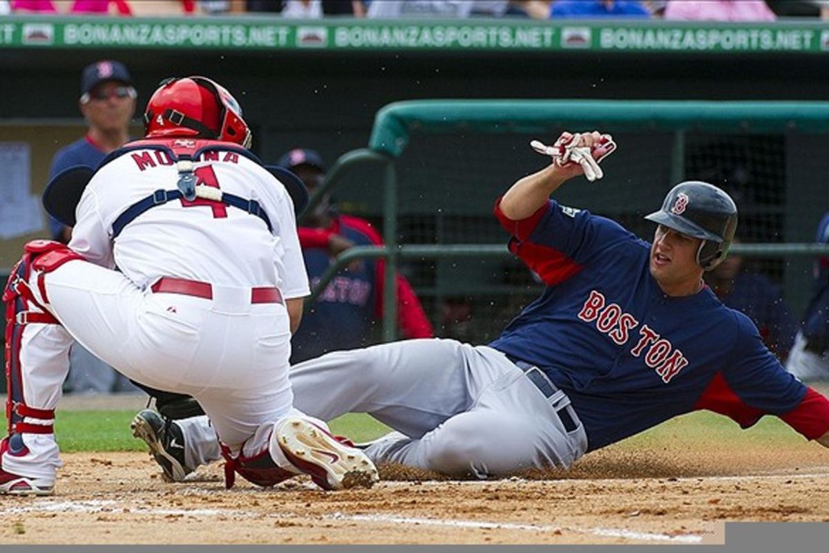 Jupiter, FL. USA; St. Louis Cardinals catcher Yadier Molina (4) tags out Boston Red Sox right fielder Alex Hassan (82) at Roger Dean Stadium. The Cardinals defeated the Red Sox 9-3. Mandatory Credit: Scott Rovak-US PRESSWIRE