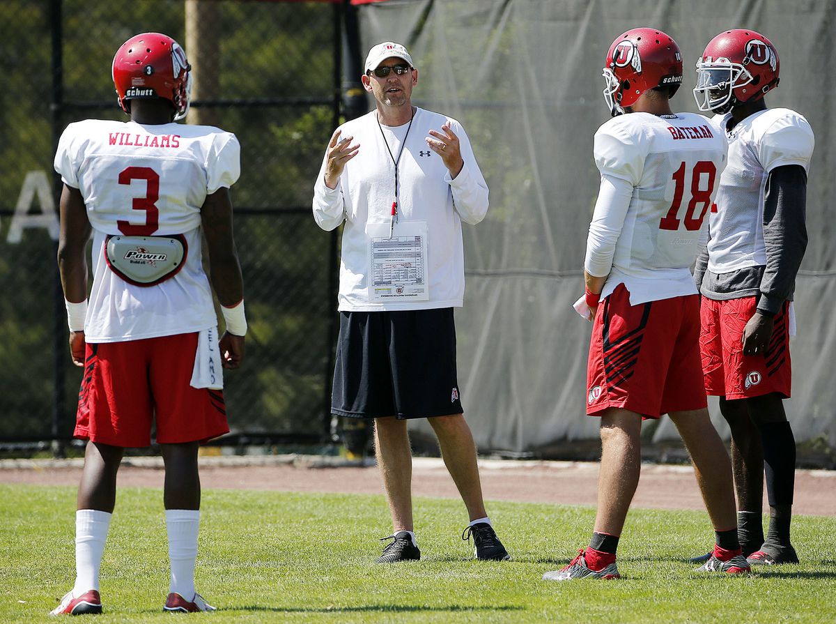 Offensive coordinator Troy Taylor talks with quarterbacks during University of Utah football practice in Salt Lake City on Thursday, Aug. 10, 2017.