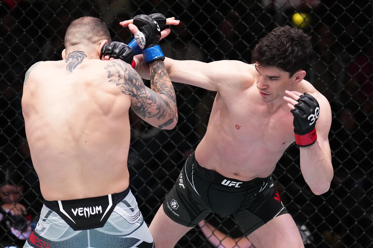 (R-L) Mike Malott battles Yohan Lainesse of Canada in a welterweight fight during the UFC Fight Night event at UFC APEX on February 25, 2023 in Las Vegas, Nevada.