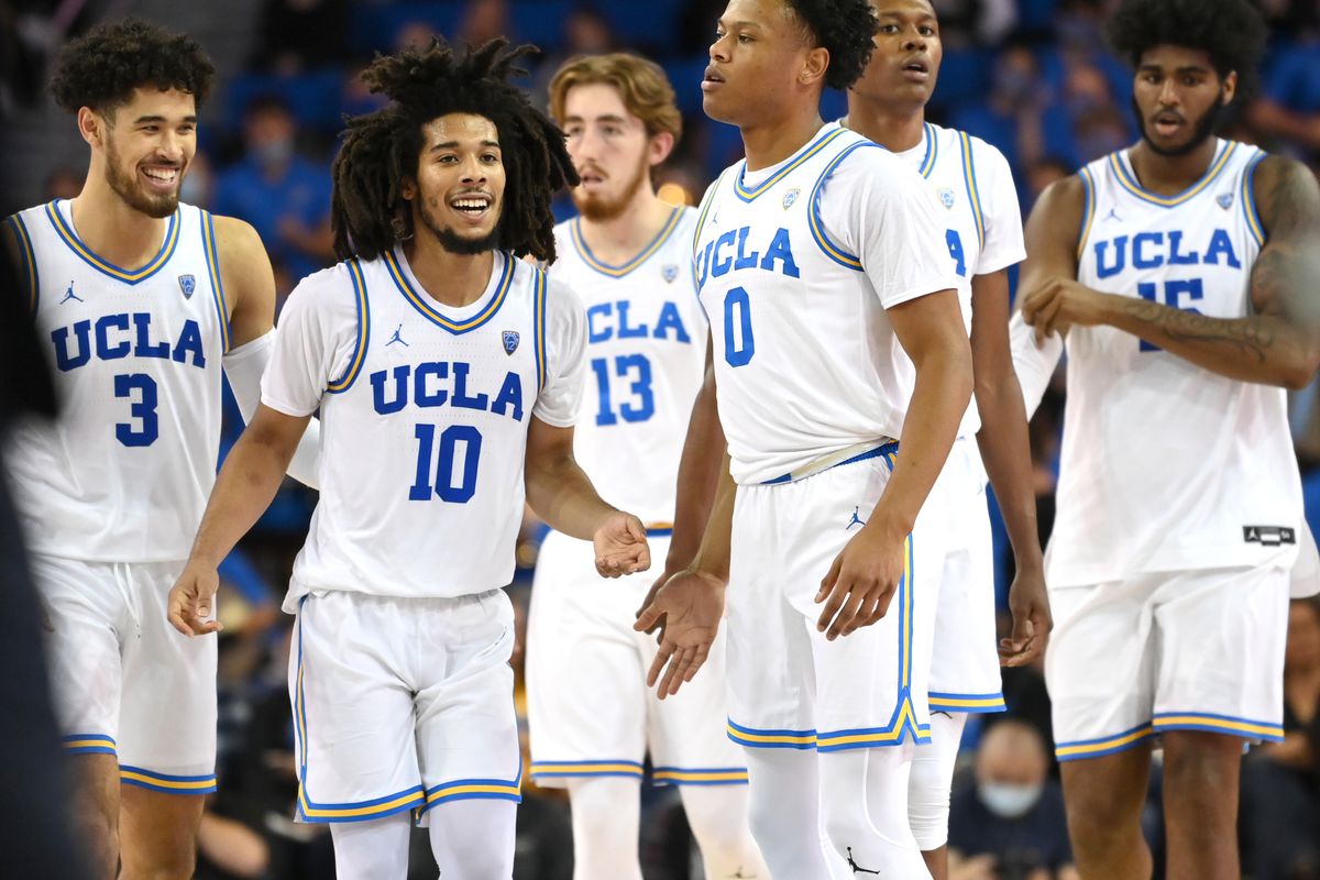UCLA Bruins guard Johnny Juzang, guard Tyger Campbell, guard Jake Kyman, guard Jaylen Clark, guard Peyton Watson and center Myles Johnson during a time out on the court in the second half against the Cal State Bakersfield Roadrunners at Pauley Pavilion.