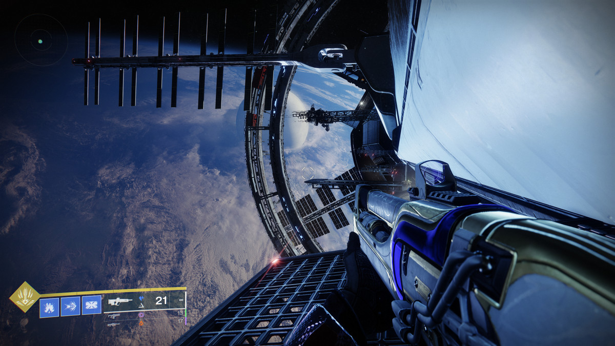 A Destiny 2 Guardian stands in space over earth on a powerful space station