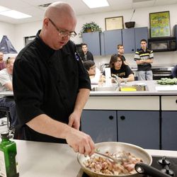 Chef J. Looney demonstrates how to prepare collard greens with bacon, onion and grits during a Cultural Aspects of Food class at the University of Utah in Salt Lake City on Tuesday, July  3, 2012. 