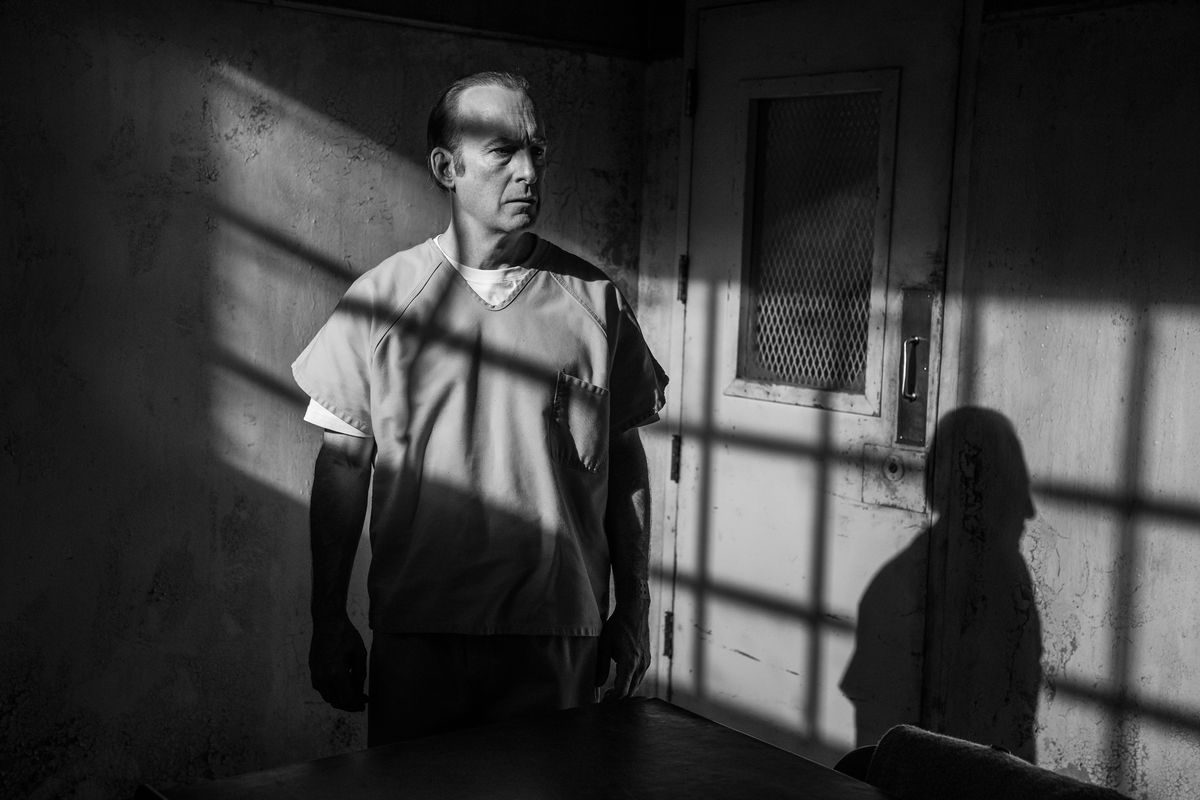 a black-and-white shot of Jimmy McGill in prison; the light from the window makes a windowpane shadow on his face and on the wall next to him