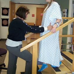 Tayler Hansen, right, does physical therapy after surgery for scoliosis. Hansen was an active teenage girl and cheerleader developed scoliosis, curvature of the spine. Her doctor at Primary Children's Medical Center is considered one of the world's experts.