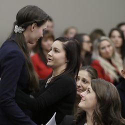 Former gymnast Rachael Denhollander, left, is hugged by Kaylee Lorincz after giving her victim impact statement during the seventh day of Larry Nassar's sentencing hearing Wednesday, Jan. 24, 2018, in Lansing, Mich. Nassar has admitted sexually assaulting athletes when he was employed by Michigan State University and USA Gymnastics, which is the sport's national governing organization and trains Olympians. (AP Photo/Carlos Osorio)