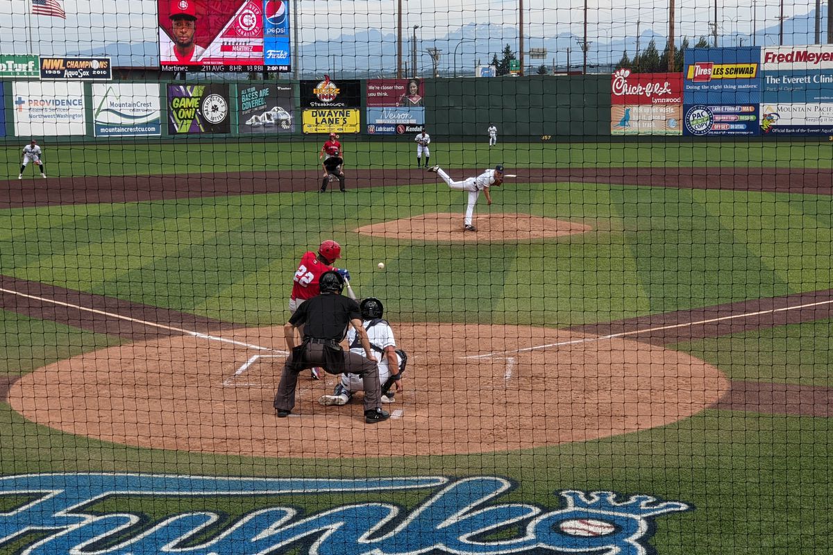 Orelvis Martinez (#22) of the Vancouver Canadians connects with a Tim Elliott pitch for a home run against the Everett AquaSox at Funko Field in Everett, WA.
