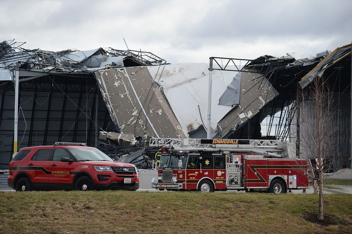 First responders surround a damaged Amazon Distribution Center on December 11, 2021 in Edwardsville, Illinois. 