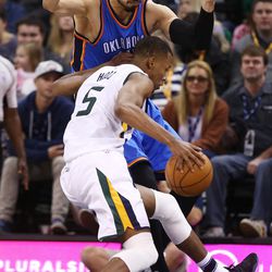 Utah Jazz guard Rodney Hood (5) drives on Oklahoma City Thunder center Enes Kanter (11) as the Jazz and the Thunder play at Vivint Smart Home arena in Salt Lake City on Wednesday, Dec. 14, 2016.