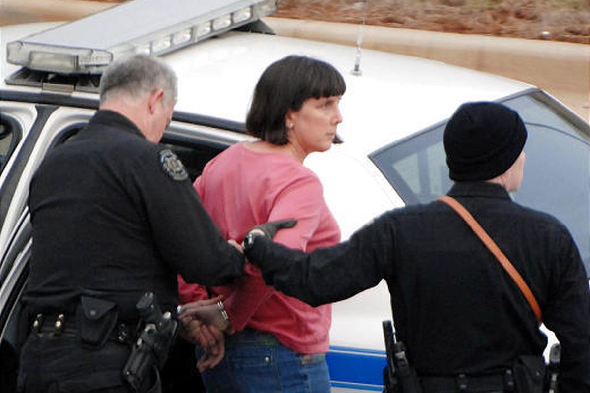 Amy Bishop is taken into custody by  police on the University of Alabama in Huntsville campus Friday.