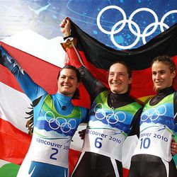 Silver medalist Nina Reithmayer of Austria, gold medalist Tatjana Huefner of Germany and bronze medalist Natalie Geisenberger of Germany celebrate wining the women's singles luge event Tuesday at the 2010 Winter Olympics at Whistler Sliding Centre.