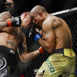 Max Holloway delivers a body shot to Jose Aldo at UFC 218.
