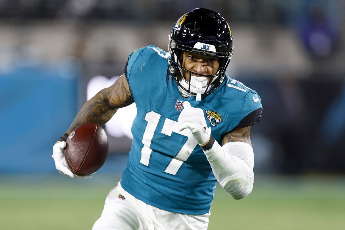 Evan Engram #17 of the Jacksonville Jaguars carries the ball against the Los Angeles Chargers during the second half of the game in the AFC Wild Card playoff game at TIAA Bank Field on January 14, 2023 in Jacksonville, Florida.