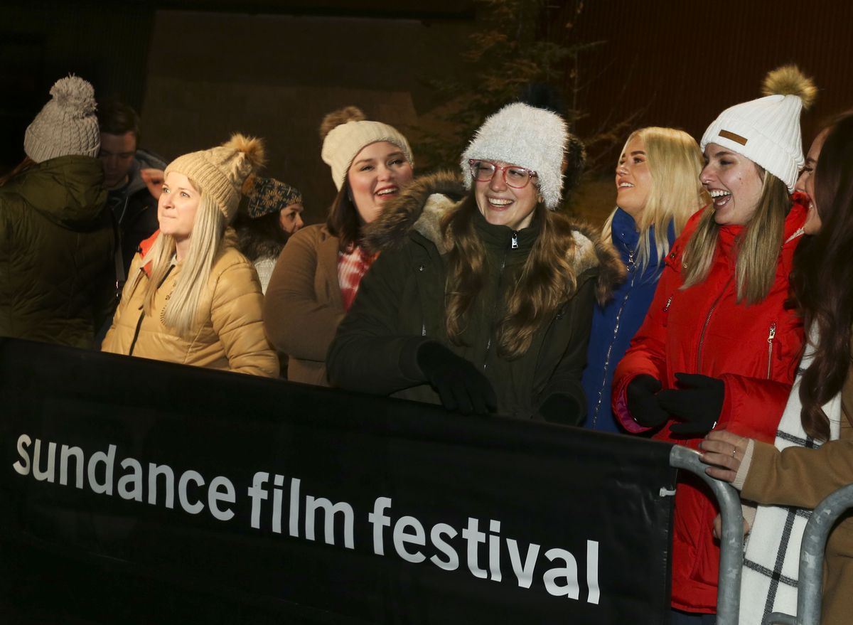 Taylor Swift fans wait in line in hopes of seeing Swift when she arrives for the Sundance Film Festival premiere of ”Miss Americana” at the Eccles Theatre in Park City on Thursday, Jan. 23, 2020.