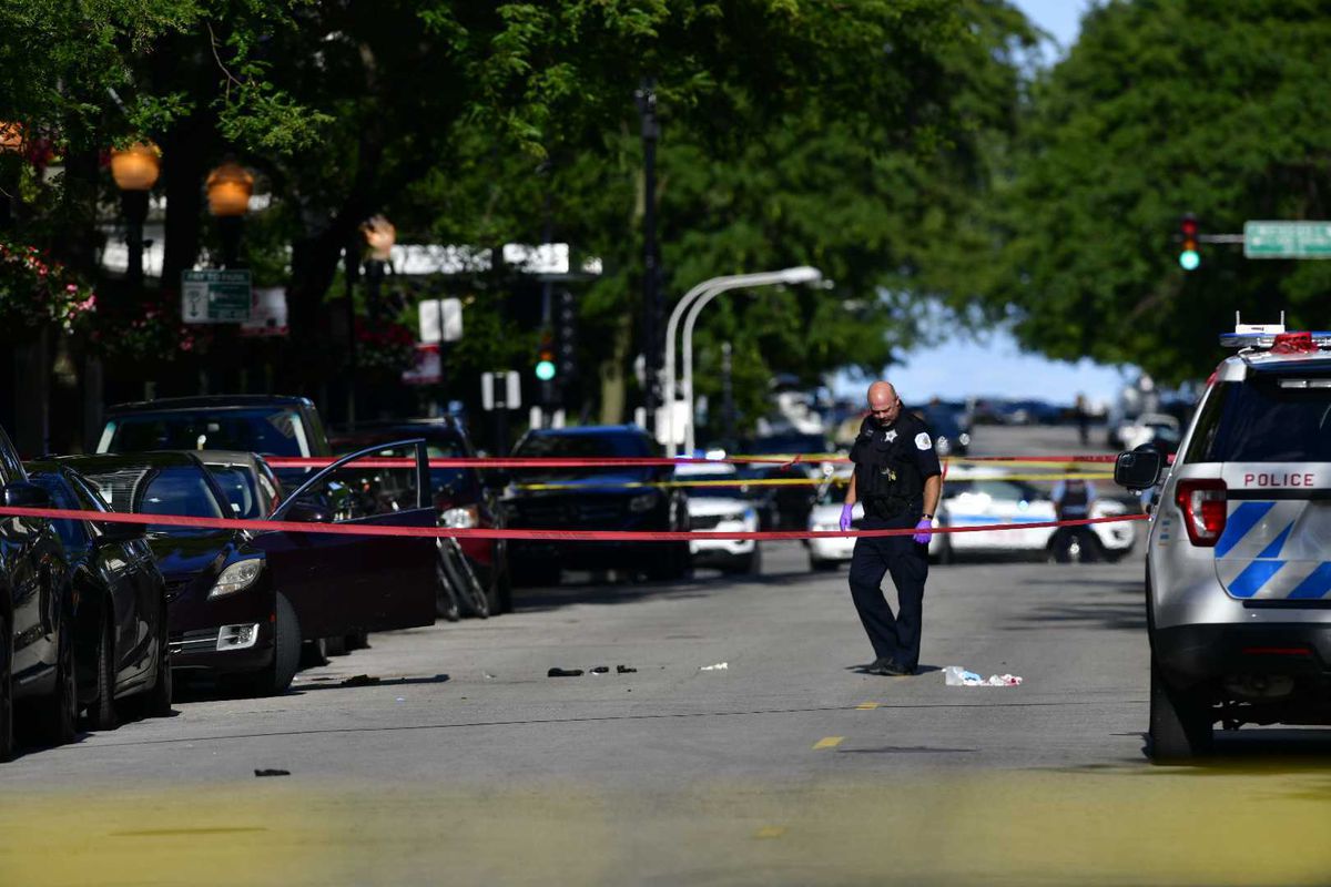 Chicago police investigate the scene where three people were shot Aug. 4, 2020, in the Gold Coast neighborhood.
