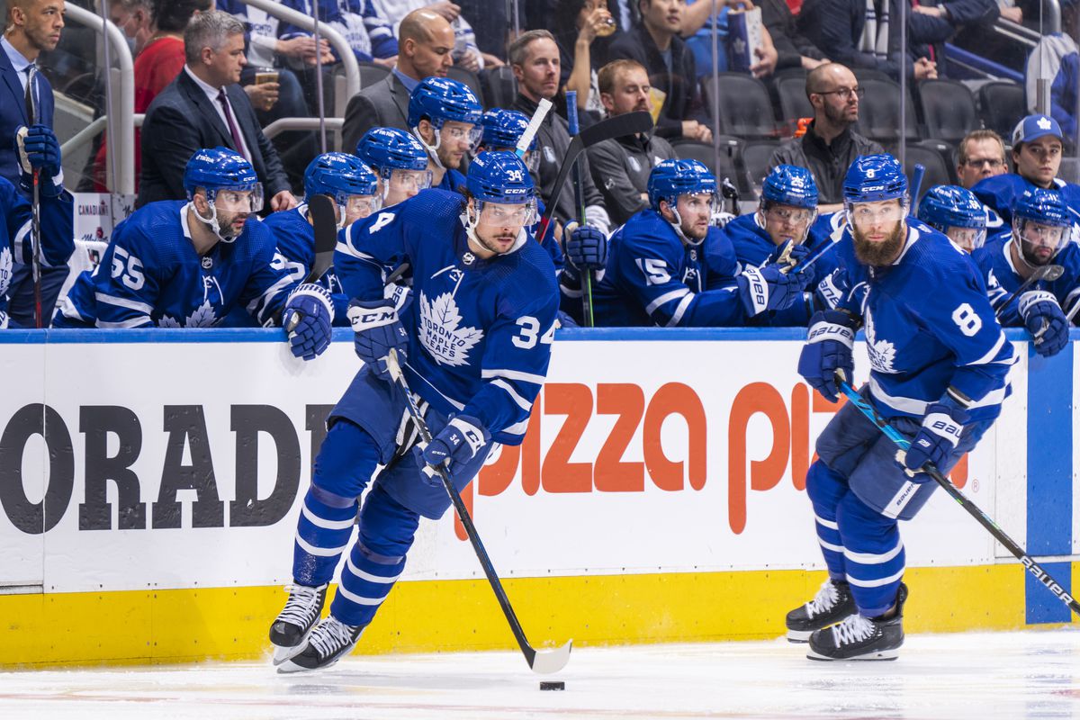 Auston Matthews #34 and Jake Muzzin #8 of the Toronto Maple Leafs skates against the Tampa Bay Lightning during the second period in Game Five of the First Round of the 2022 Stanley Cup Playoffs at the Scotiabank Arena on May 10, 2022 in Toronto, Ontario, Canada.