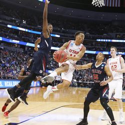 Utah Utes guard Brandon Taylor (11) drives on Fresno State Bulldogs guard Lionel Ellison III (15) during the NCAA Tournament in Denver on Thursday, March 17, 2016. Utah won 80-69. 