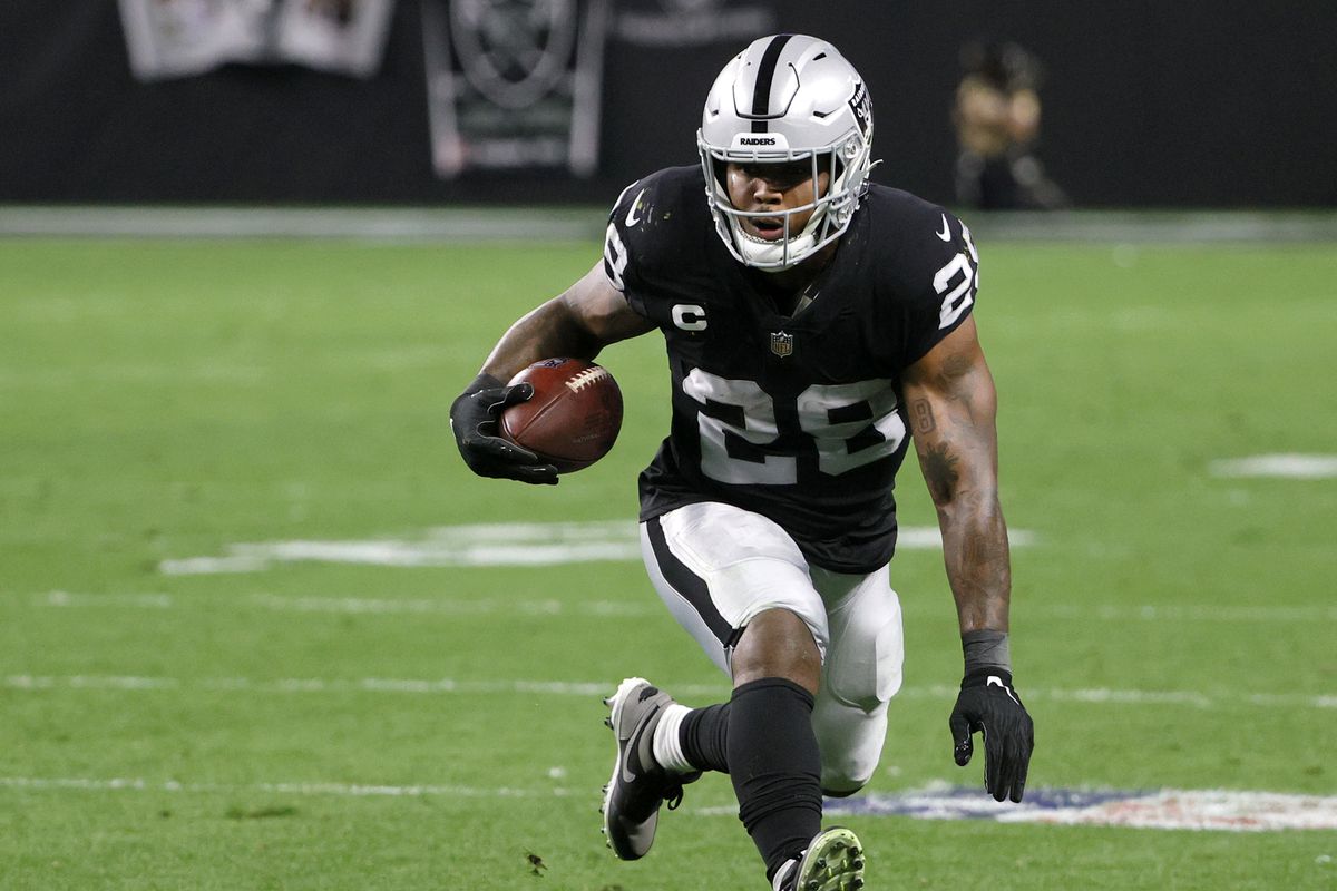 Running back Josh Jacobs #28 of the Las Vegas Raiders runs against the Los Angeles Chargers during their game at Allegiant Stadium on January 9, 2022 in Las Vegas, Nevada.