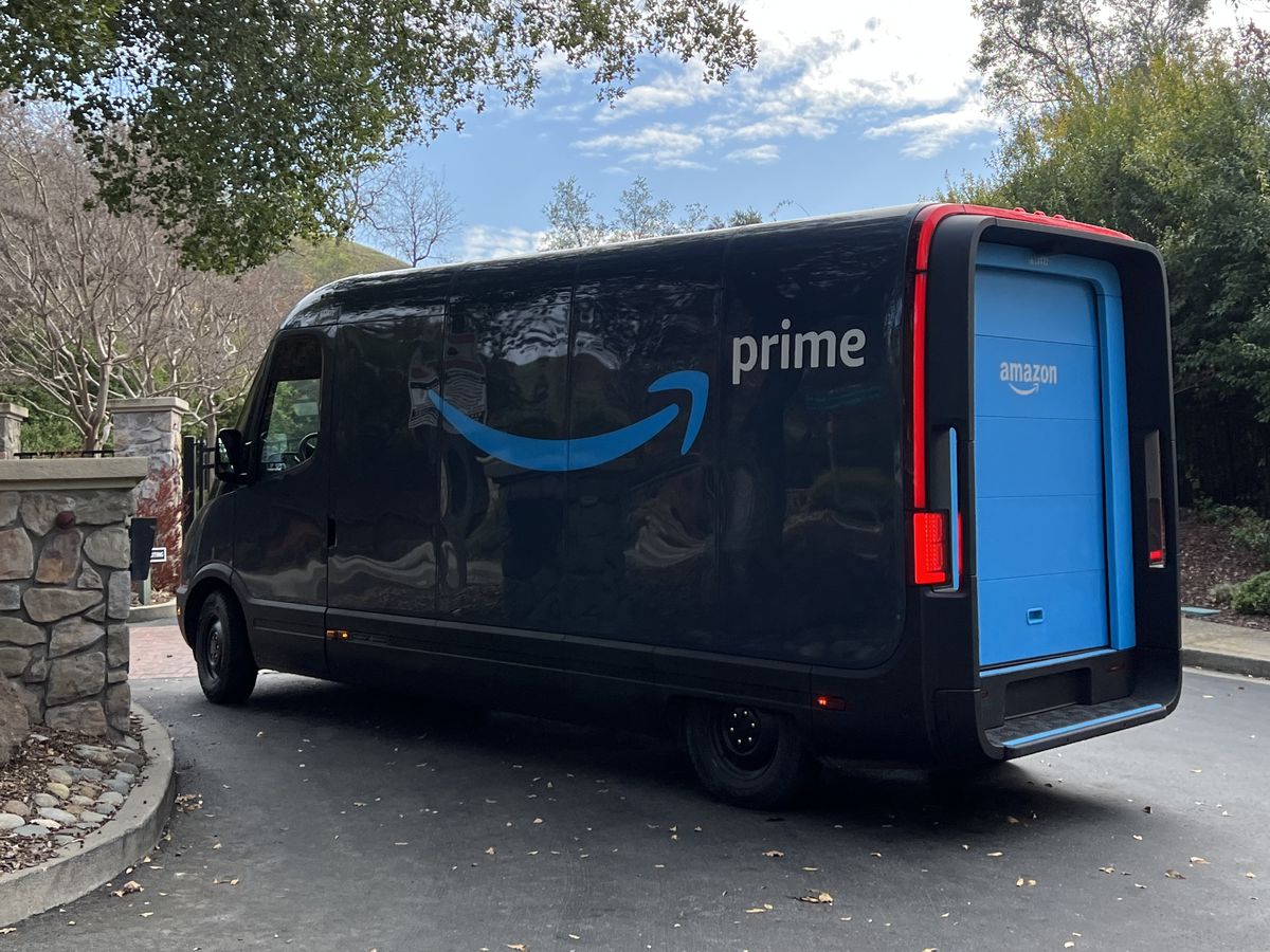 An Amazon electric delivery truck, developed by electric vehicle maker Rivian, makes deliveries in a residential neighborhood in Lafayette, California, with Amazon Prime logo visible,