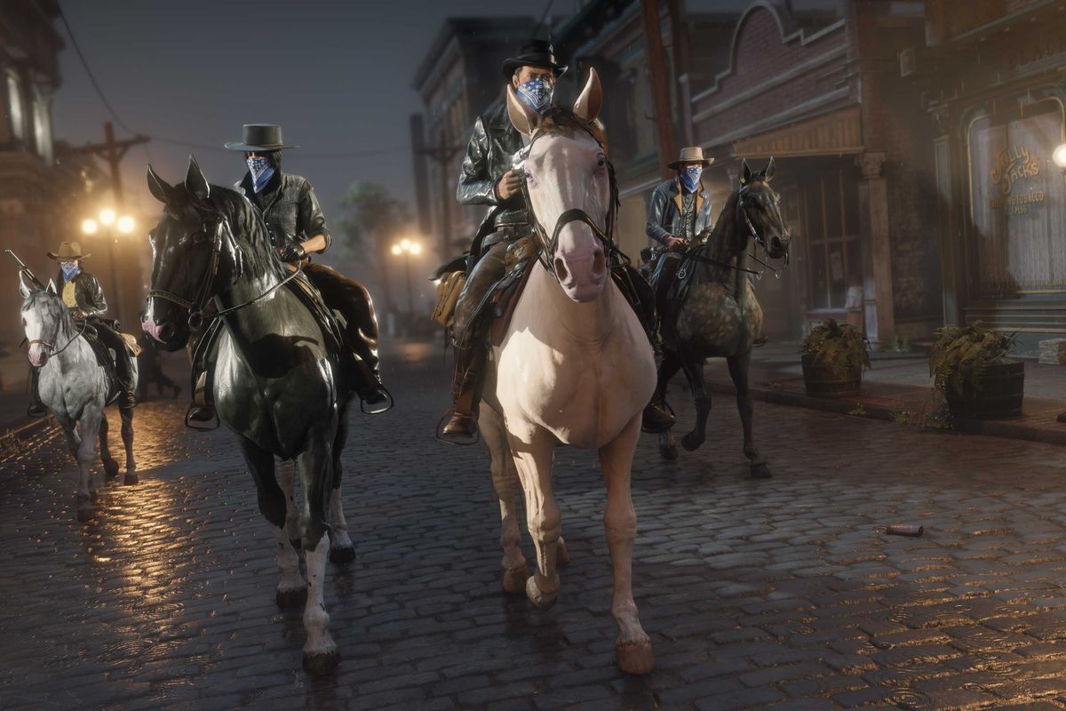 Red Dead Online - four players, equipped in cowboy gear, head through the streets of Saint Denis atop their horses.