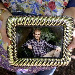 Diane Orley holds a photograph of her son, George, on the University of Michigan campus in Ann Arbor, Mich., on Wednesday, Sept. 12, 2018.. George took his own life when he was a student at the school. Diane and her son Sam got involved with the fledgling peer-to-peer Wolverine Support Network at University of Michigan after George's death.