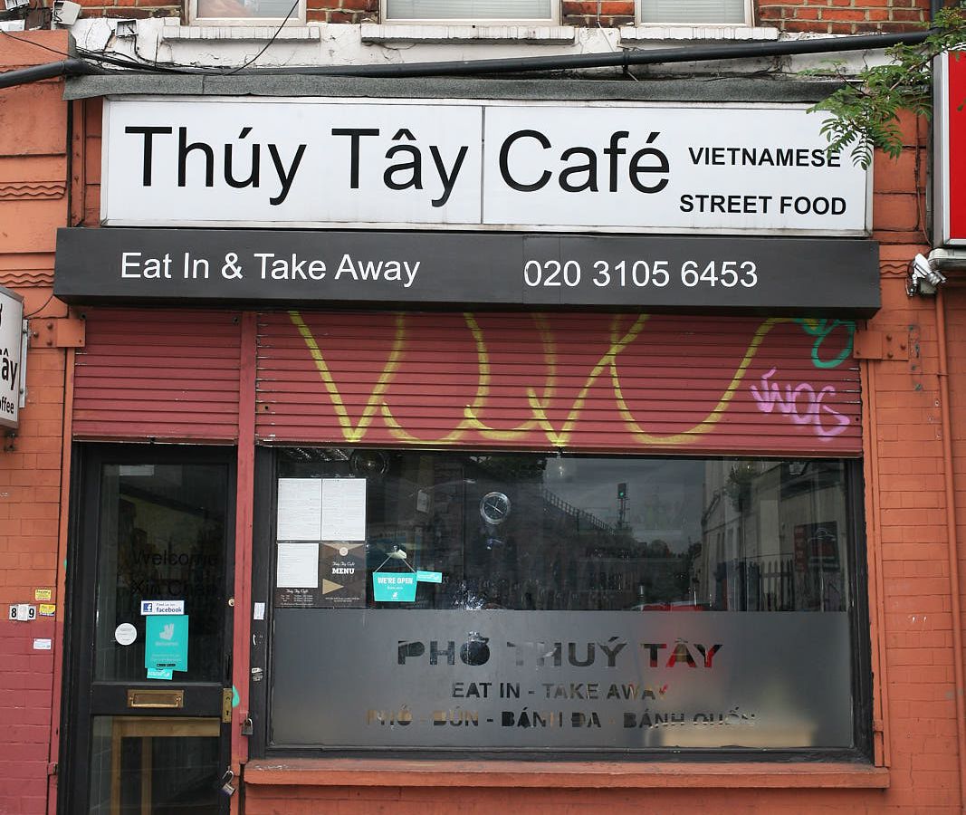 The exterior of Pho Thuy Tay Vietnamese restaurant on Old Kent Road, London, with bricks surrounding a white sign with Pho Thuy Tay written in black text