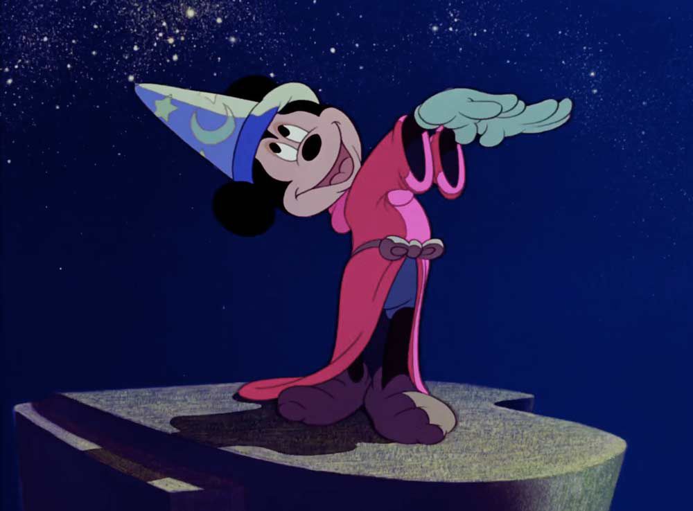 Mickey Mouse in a wizard hat waving his arms like a conductor in Fantasia.