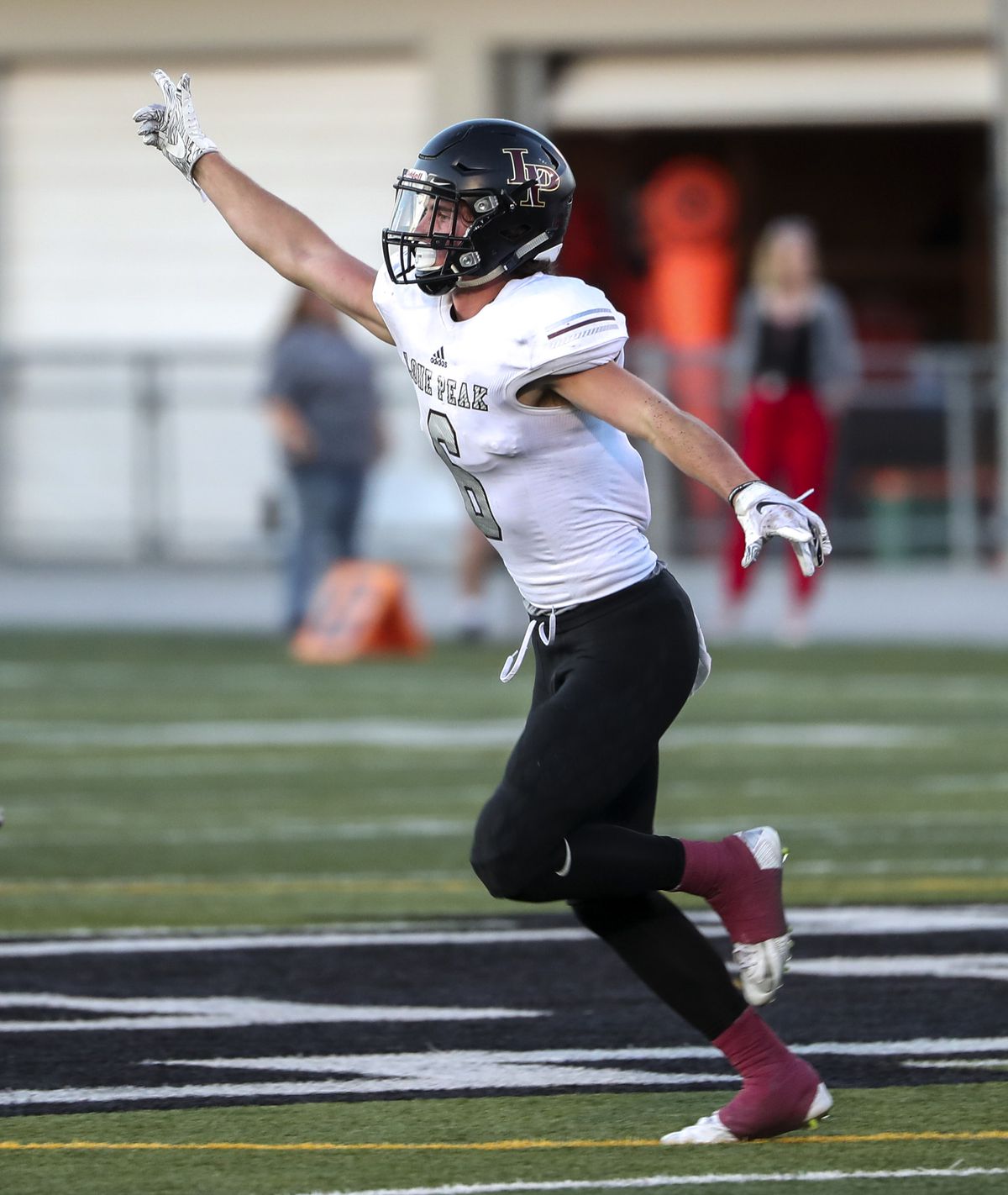 Lone Peak’s Nate Ritchie celebrates after intercepting a Highland pass football game at Highland High School in Salt Lake City on Friday, Sept. 7, 2018.