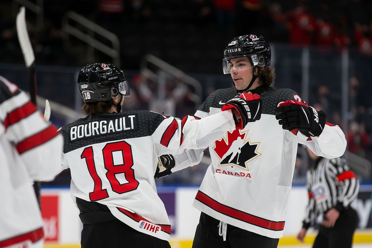 Xavier Bourgault #18 and Owen Power #25 of Canada celebrate a goal against Czechia in the first period during the 2022 IIHF World Junior Championship at Rogers Place on December 26, 2021 in Edmonton, Canada.