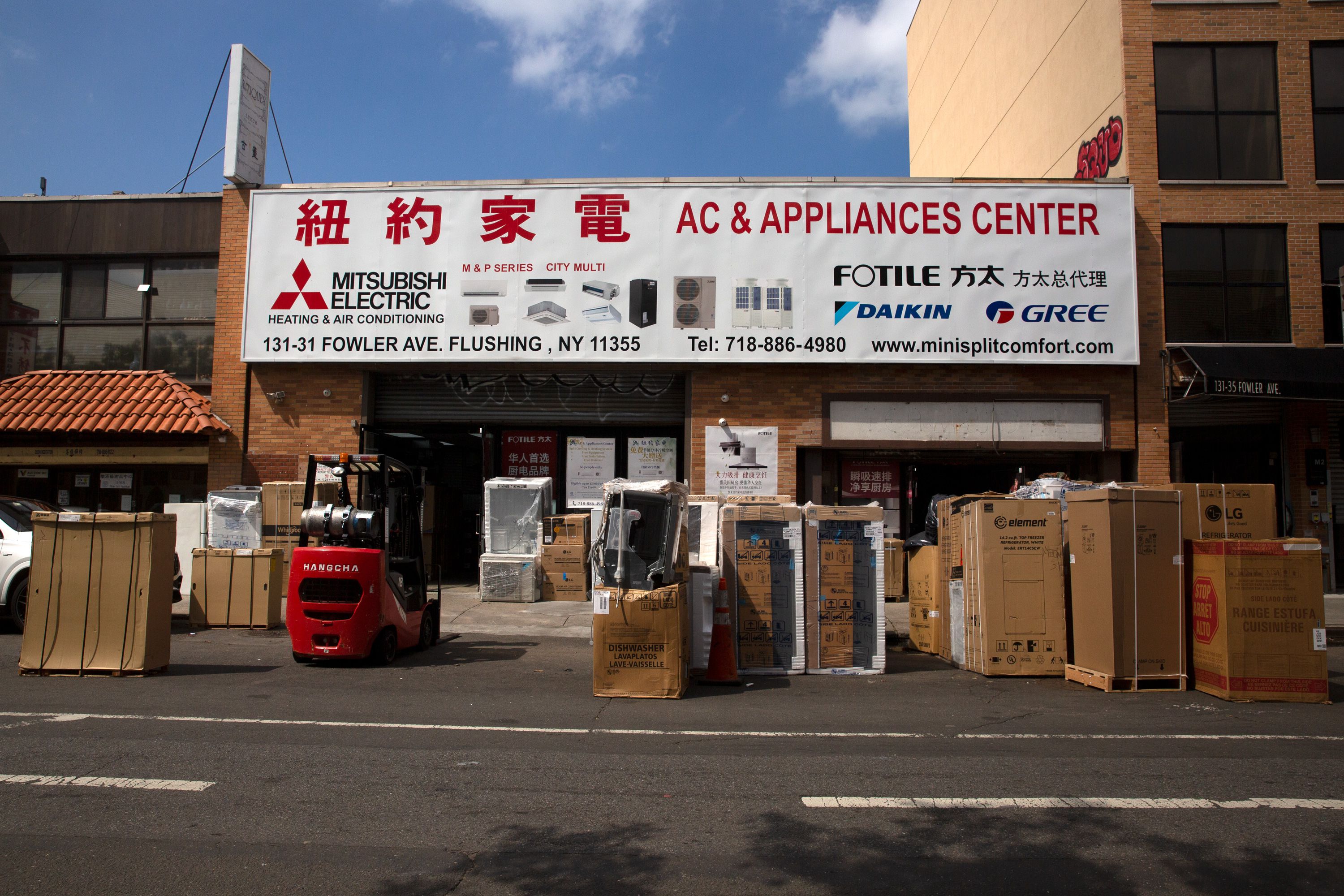 Large boxes of electronics sit in front of AC & Appliances Center in Flushing.