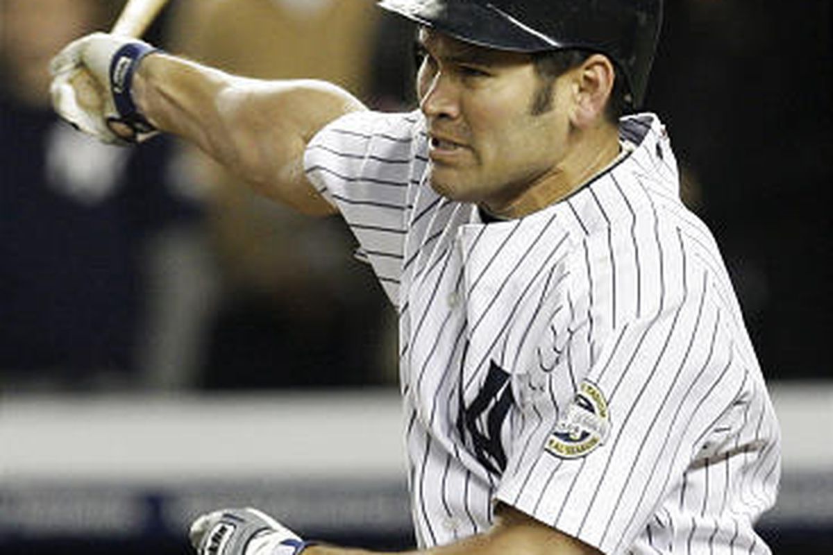 In this Oct. 25, 2009, file photo, New York Yankees' Johnny Damon follows through on his two-run RBI single during the fourth inning of Game 6 of the American League Championship baseball series in New York. A  person familiar with the negotiations tells 