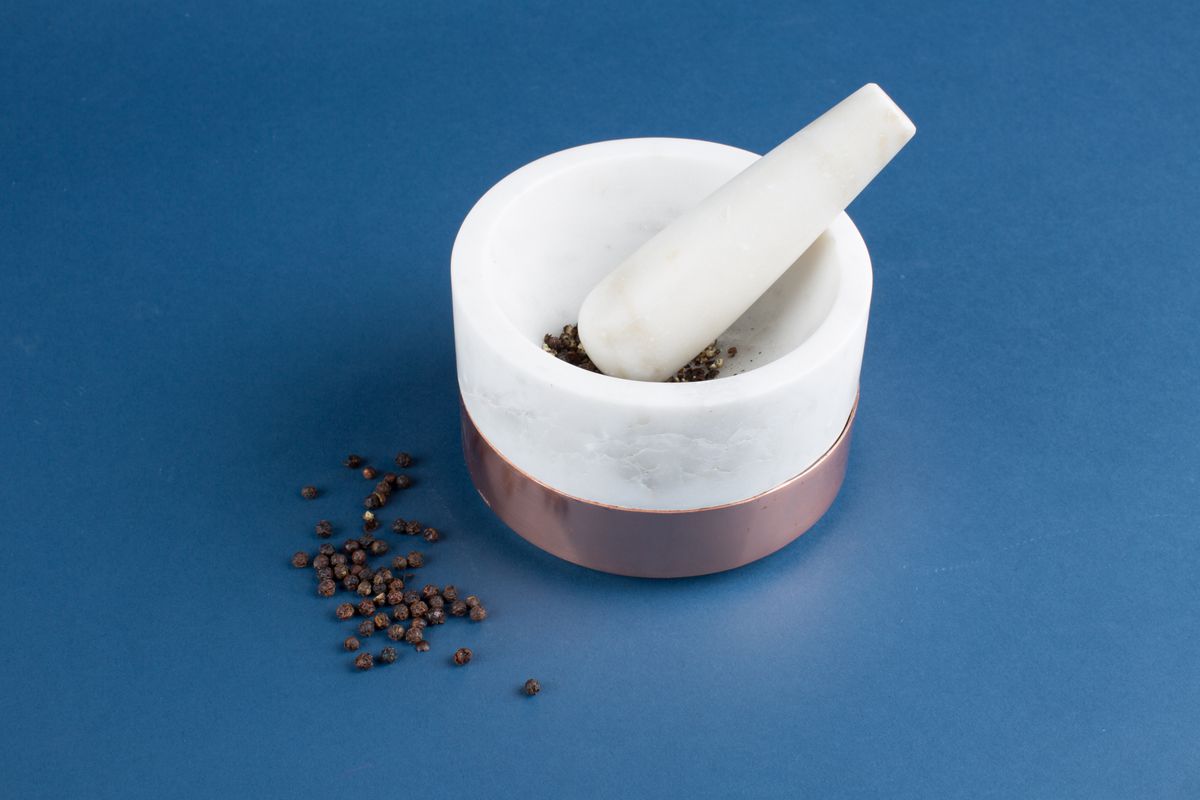 Mortar and pestle with black peppercorns
