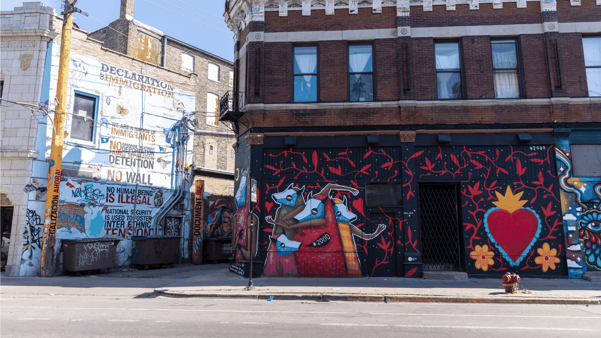 The “Declaration of Immigration,” left, and “Amor y Comunidad,” right, murals near West 18th Street and South Loomis Street in Pilsen on Wednesday.