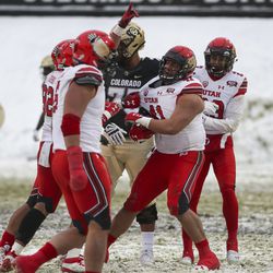Utah Utes defensive tackle Hauati Pututau (41) is mobbed by his teammates after scooping up a fumble during the University of Utah football game against the University of Colorado at Folsom Field in Boulder, Colorado, on Saturday, Nov. 17, 2018.