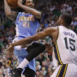 Denver's Wilson Chandler drives to the hoop on Utah's Derrick Favors as the Utah Jazz and Denver Nuggets play Wednesday, April 3, 2013 in Salt Lake City at EnergySolutions Arena. Denver beat the Jazz 113-96.
