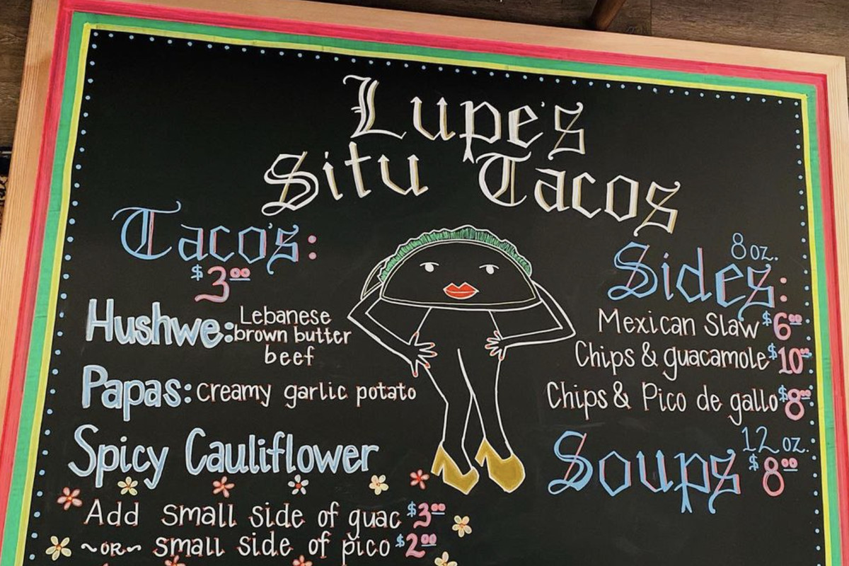 A chalkboard menu shows the selections at Lupe’s Situ Tacos