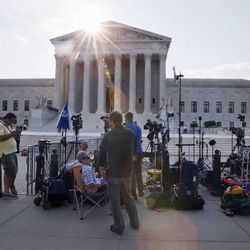 Television crews set up outside of the Supreme Court in Washington, Thursday June 25, 2015. 