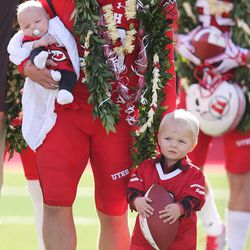Utah Utes place-kicker Andy Phillips (39) holds his boys as he is honored on senior day in Salt Lake City on Saturday, Nov. 19, 2016.